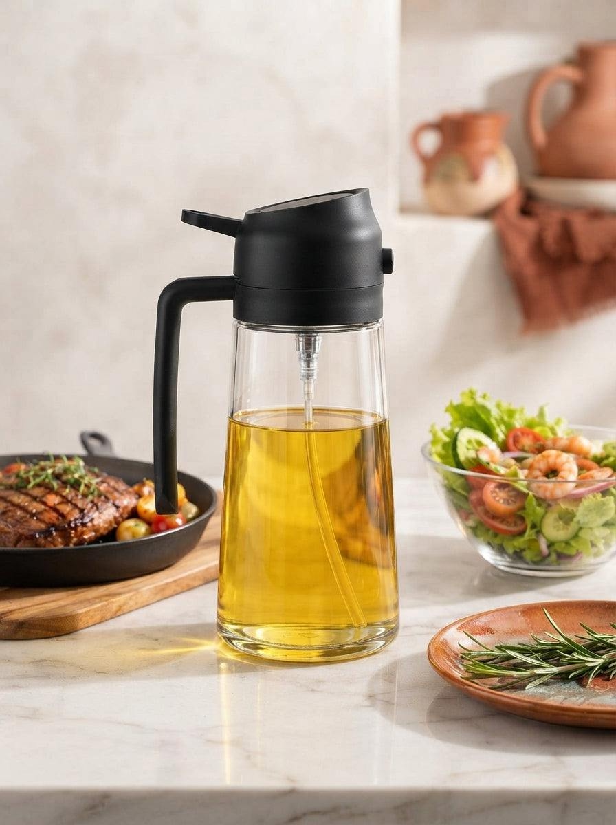 Sleek glass oil dispenser with a black handle on a marble kitchen counter with terracotta accents.
